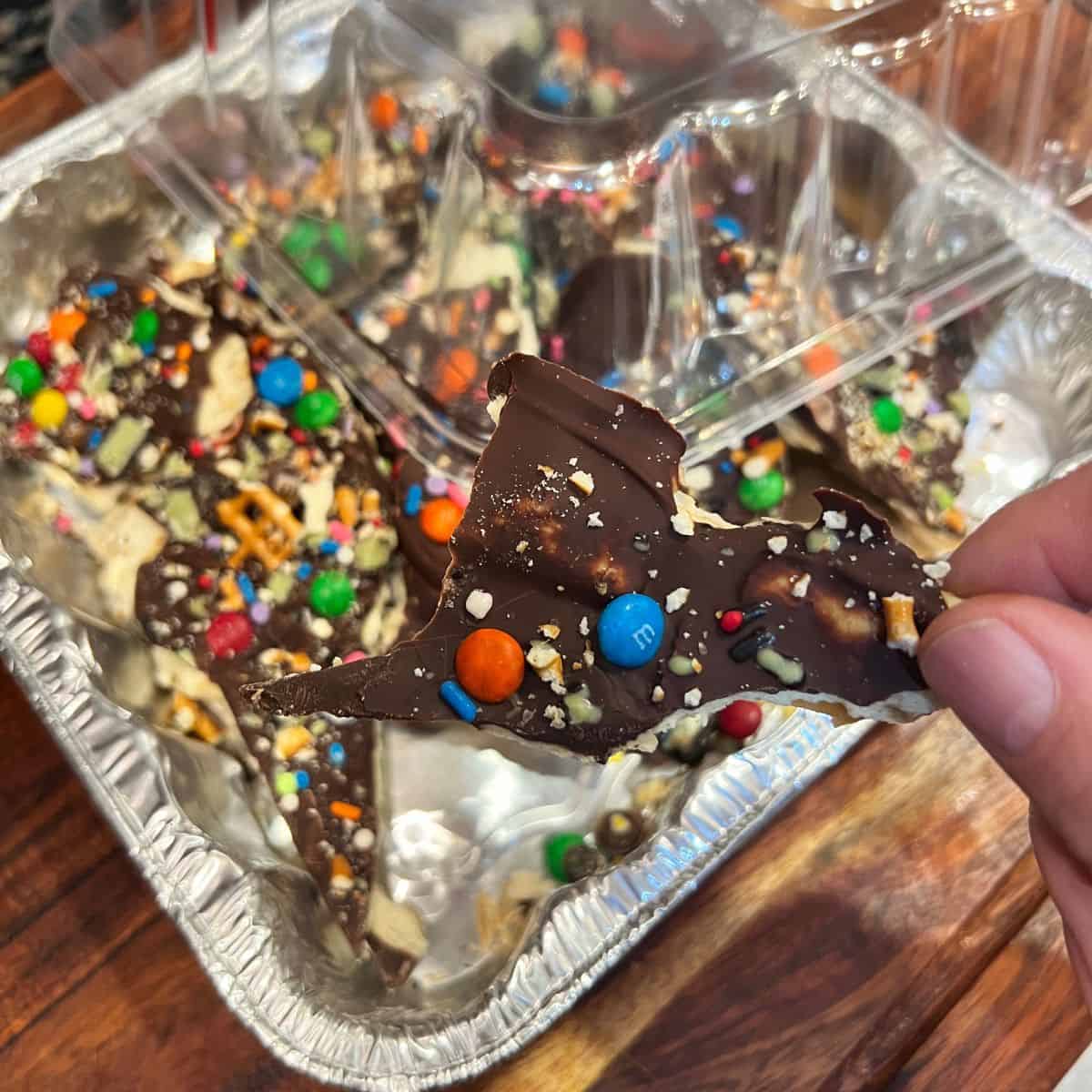 Chocolate toffee candy bark in an aluminum tin