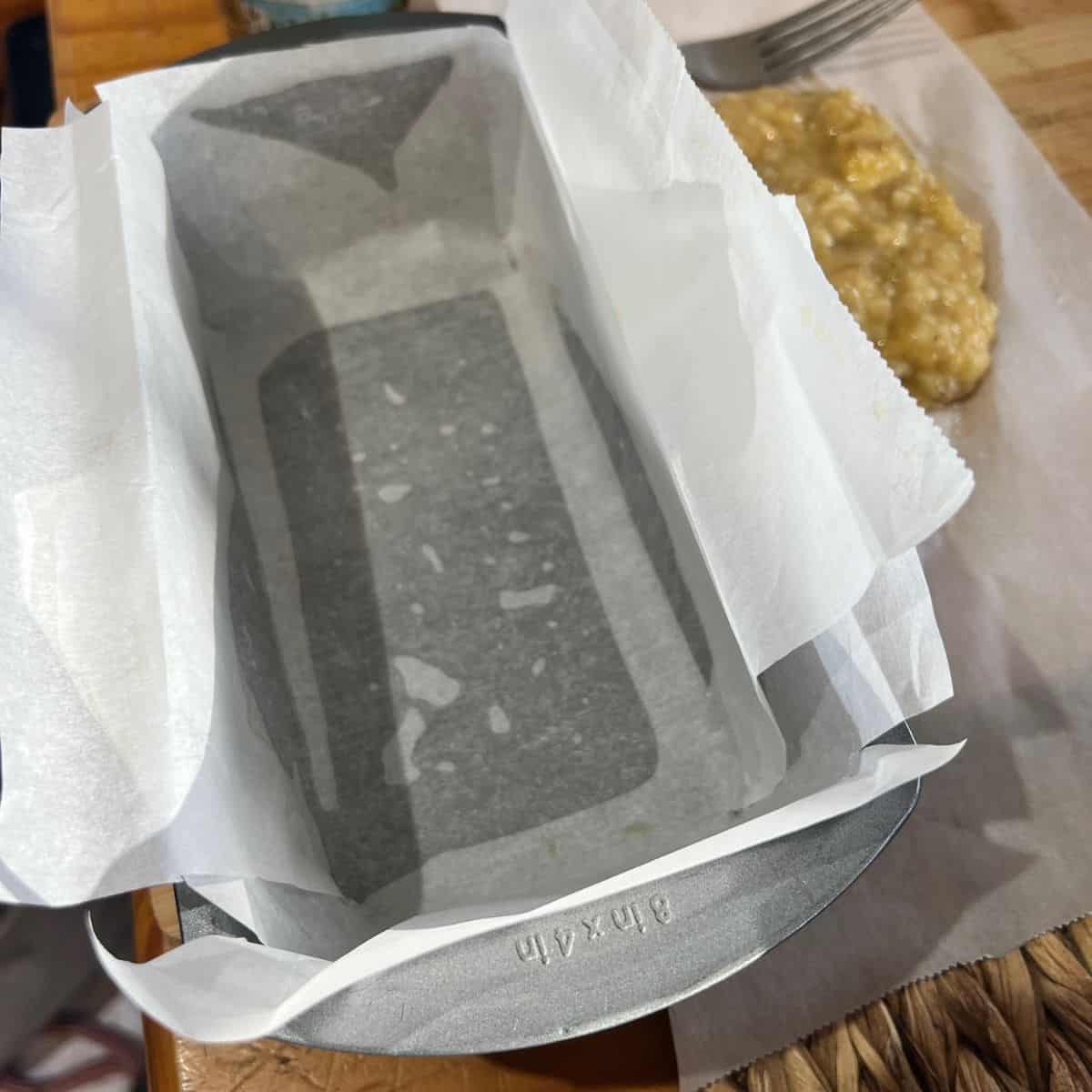 Parchment paper lined loaf pan for cottage cheese banana bread