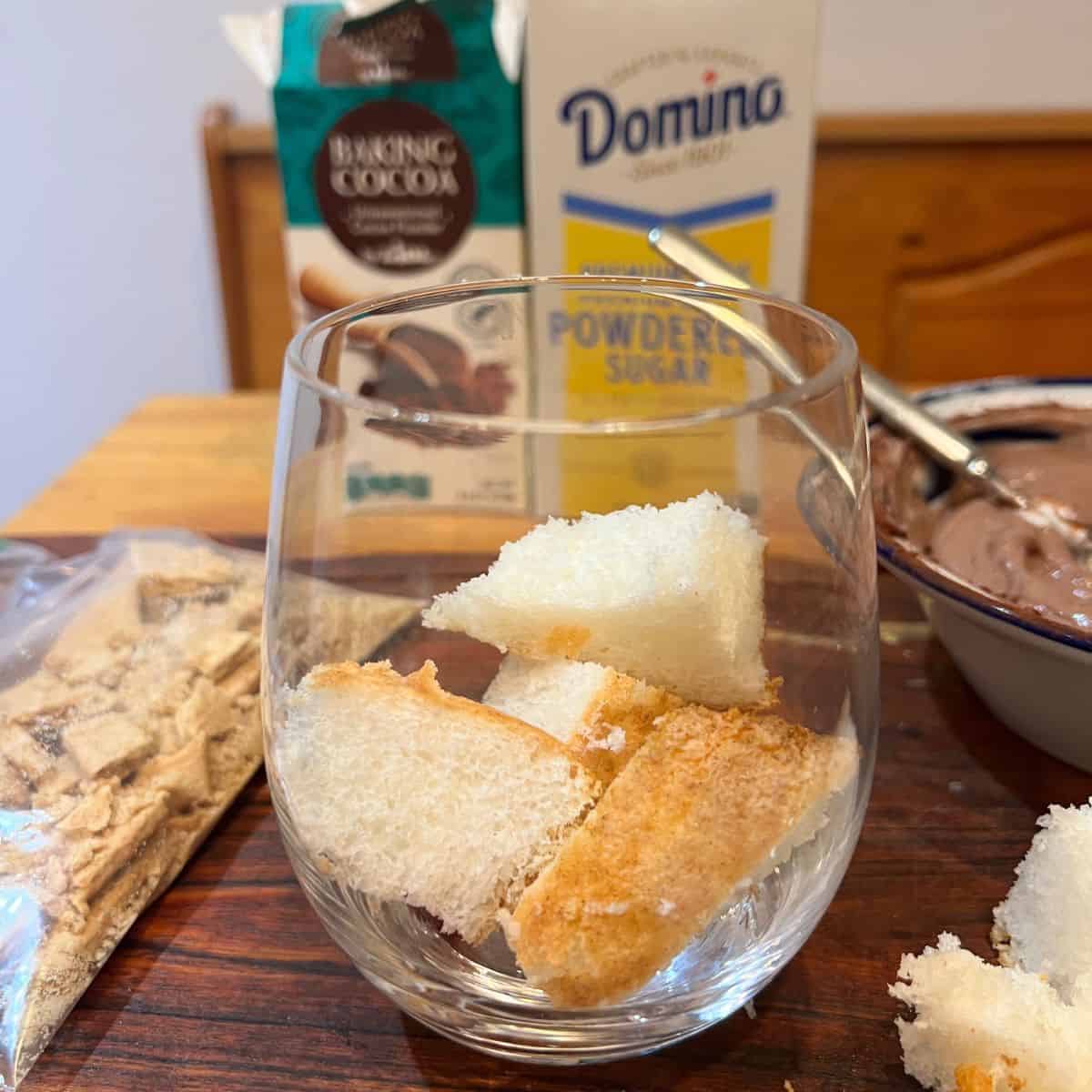 angel food cake cubes in the bottom of a parfait glass
