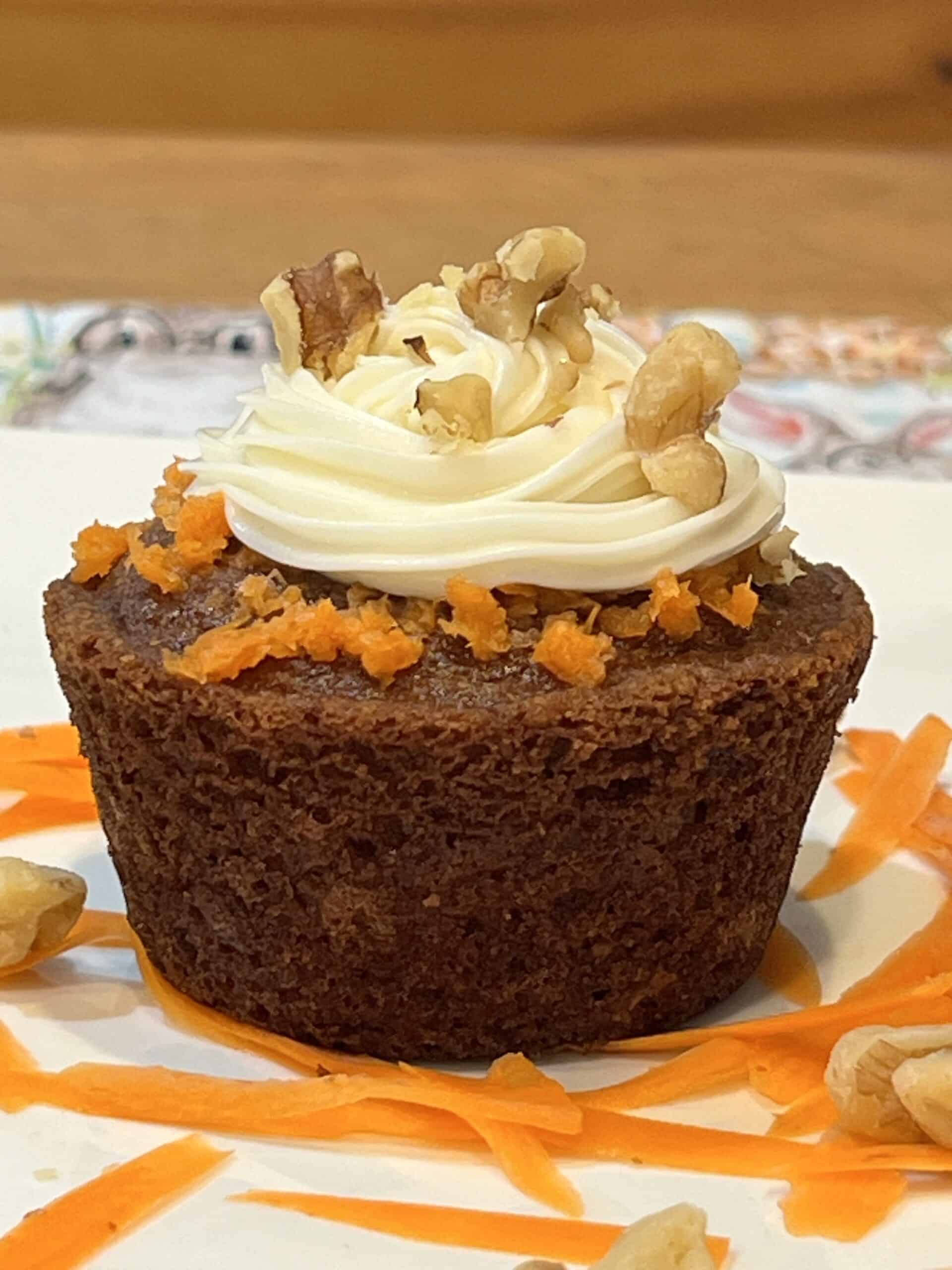 High protein carrot cake muffin with cream cheese frosting and walnuts