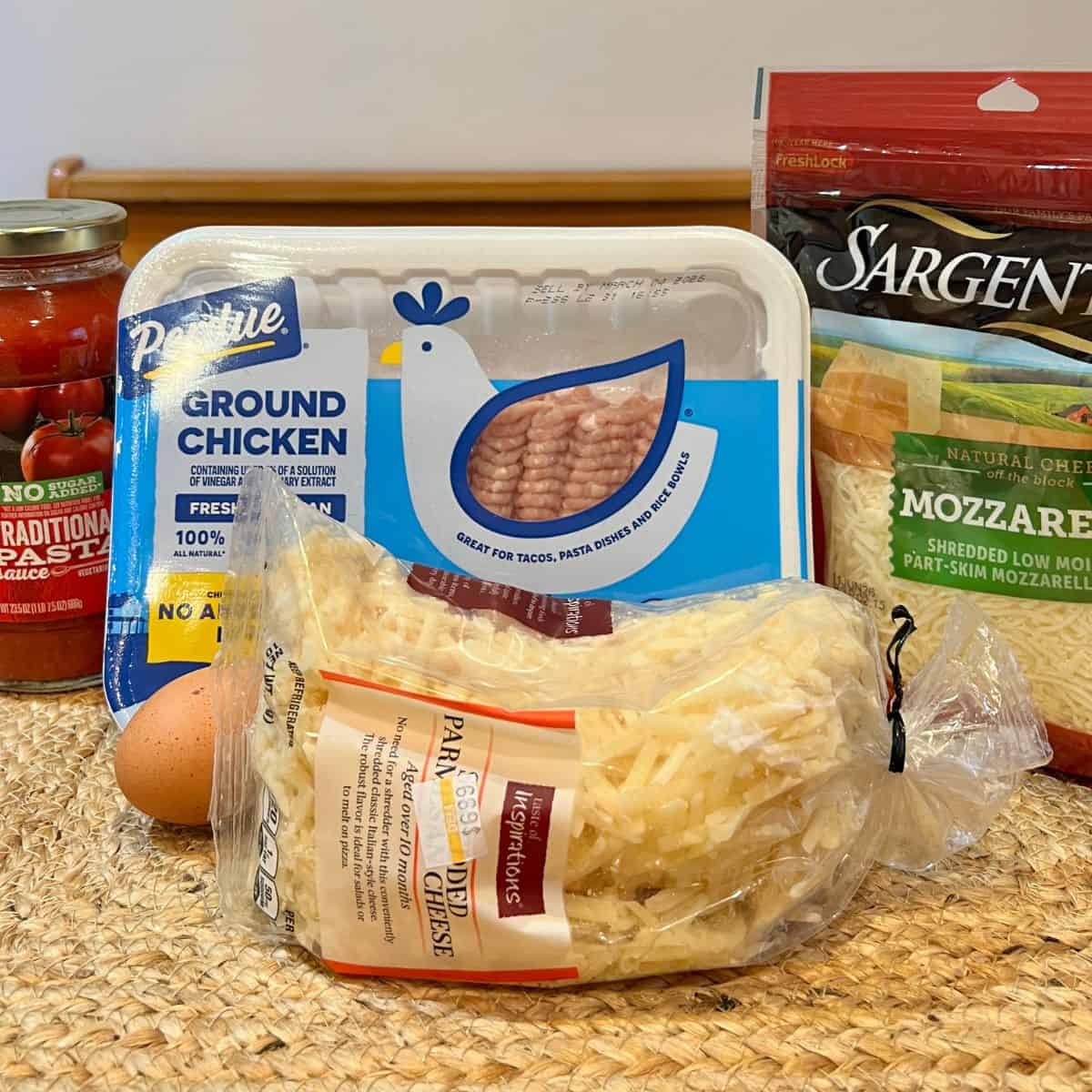 ngredients for keto chicken crust pizza including ground chicken, mozzarella cheese, parmesan, and seasonings