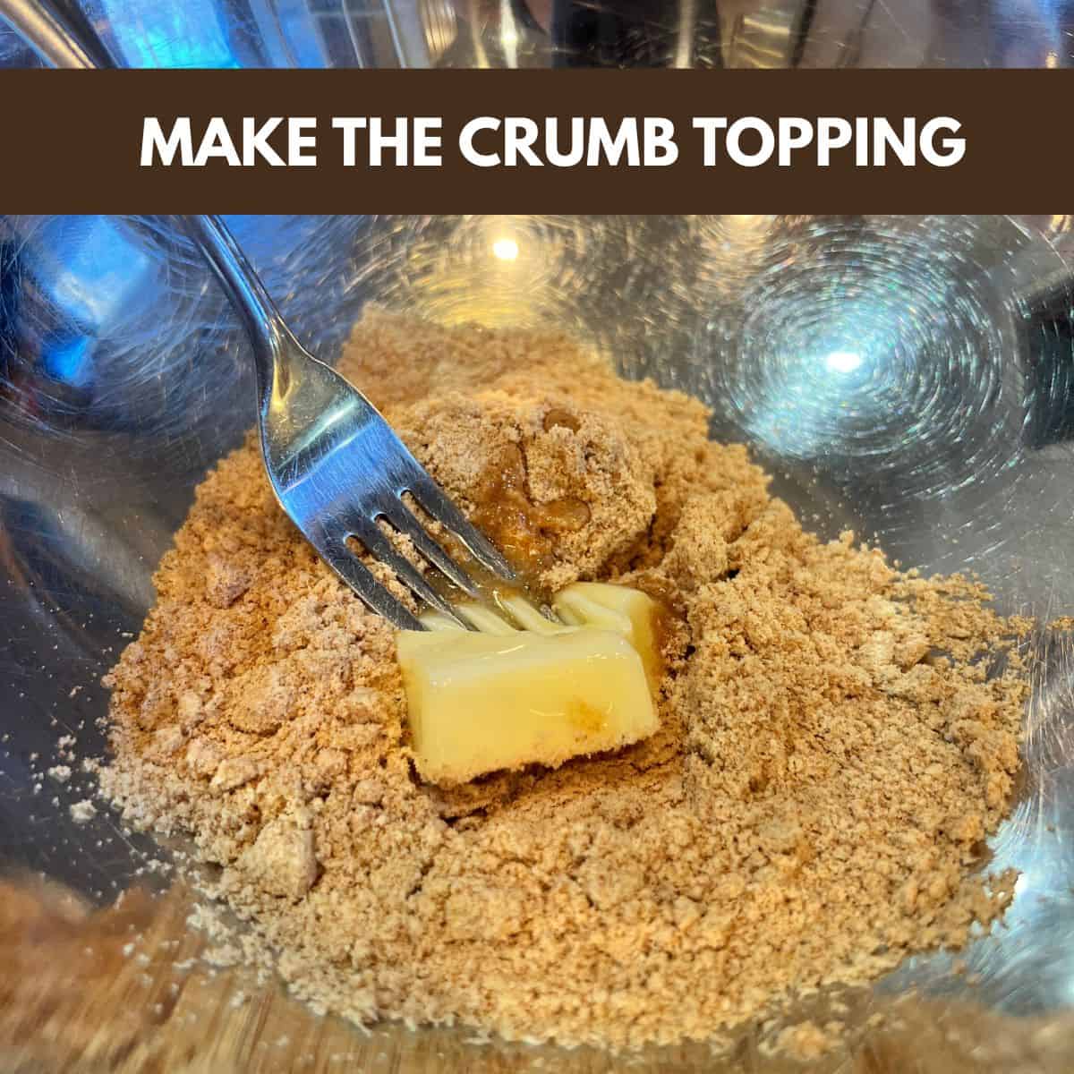 Dry coffee cake mix in a bowl being combined with softened butter using a fork to make a crumb topping