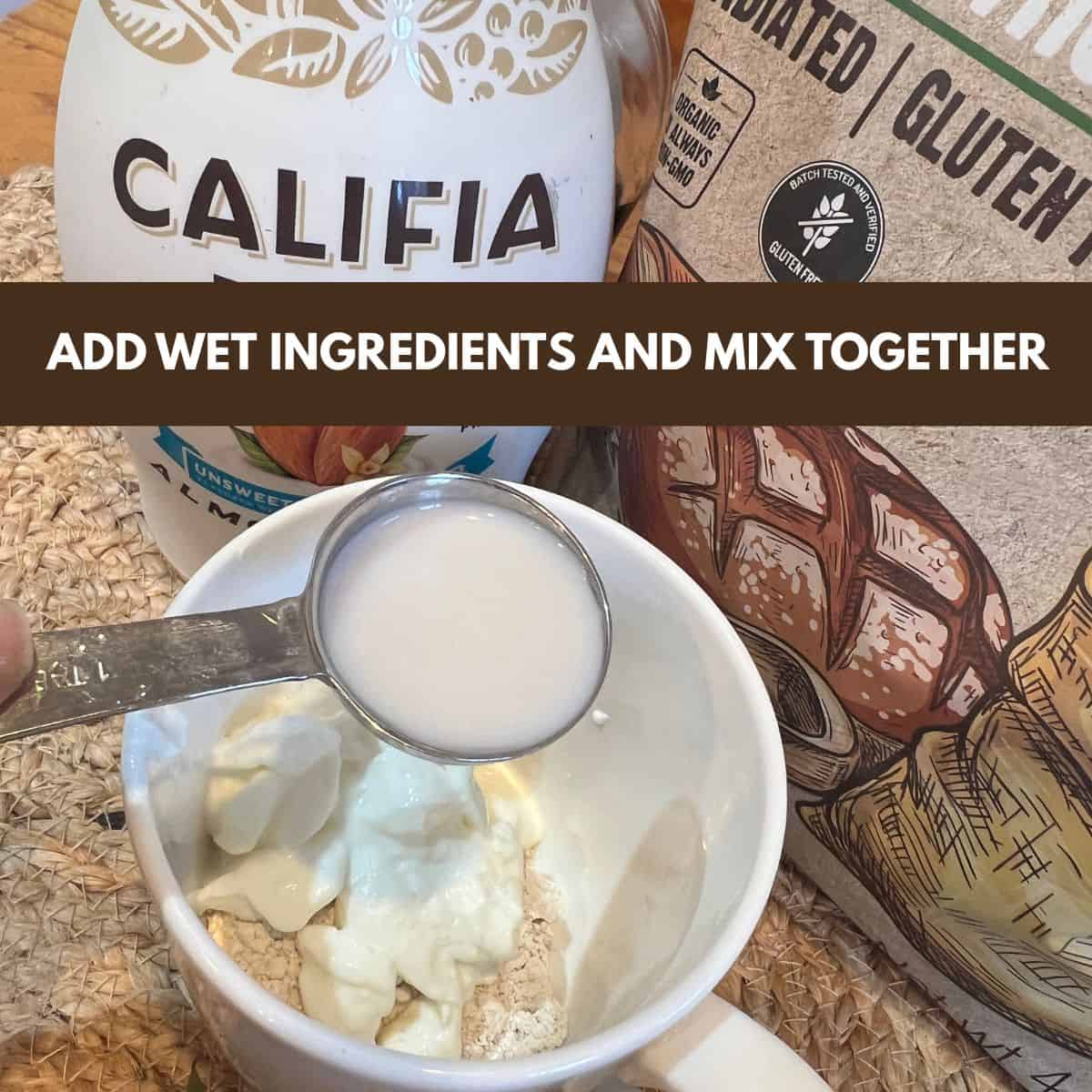 Adding unsweetened almond milk to oat flour and Greek yogurt in a mug for strawberry shortcake mug cake