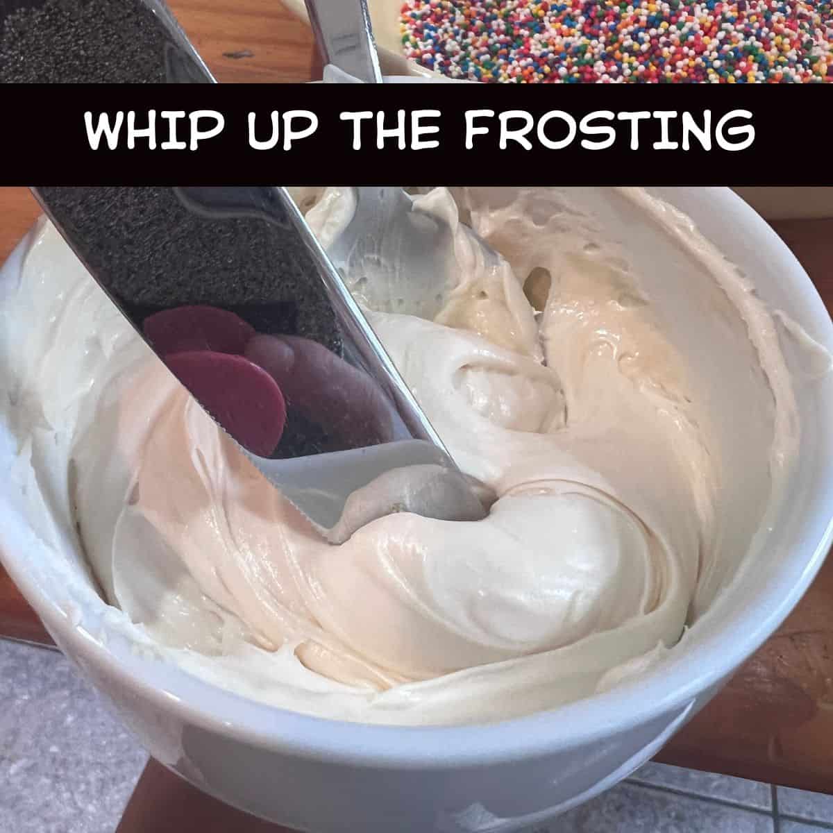 Light cream cheese and Greek yogurt frosting in a white bowl with a spoon and butter knife, ready for assembling Healthy Funfetti Dot Cake Jars.