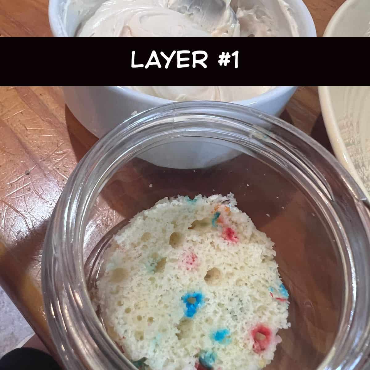 Single Funfetti cake layer placed in the bottom of a glass jar as the first layer of a Healthy Funfetti Dot Cake Jar.
