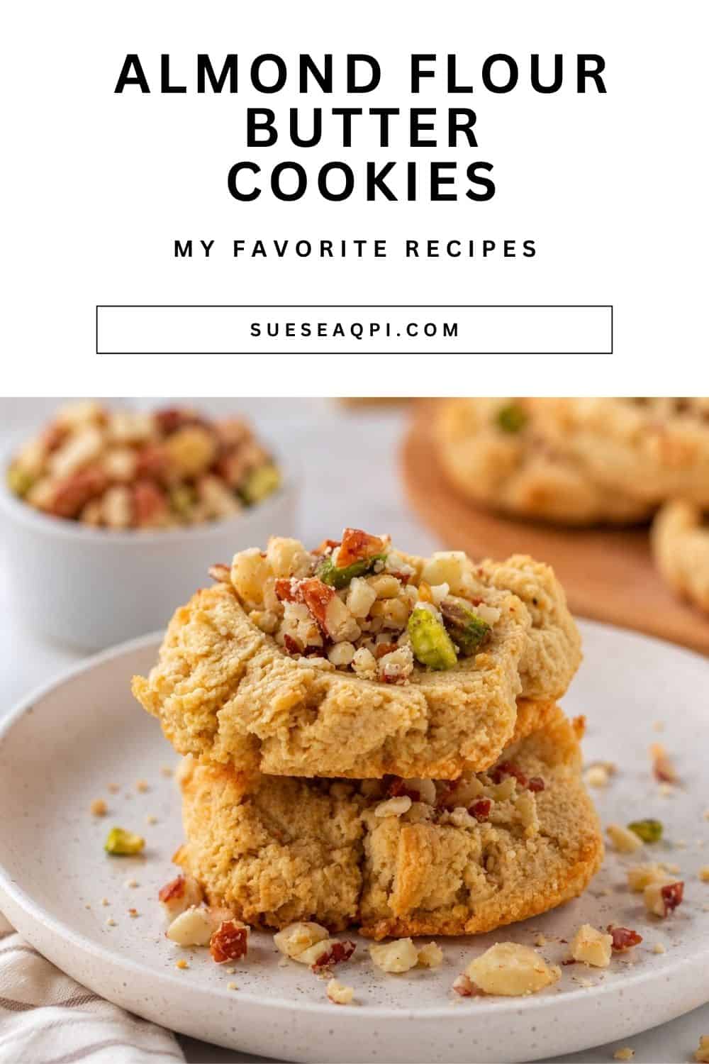 Close-up of soft almond flour butter cookies topped with crushed pecans on a white plate. These easy low-carb cookies are naturally gluten-free and made without artificial sweeteners.