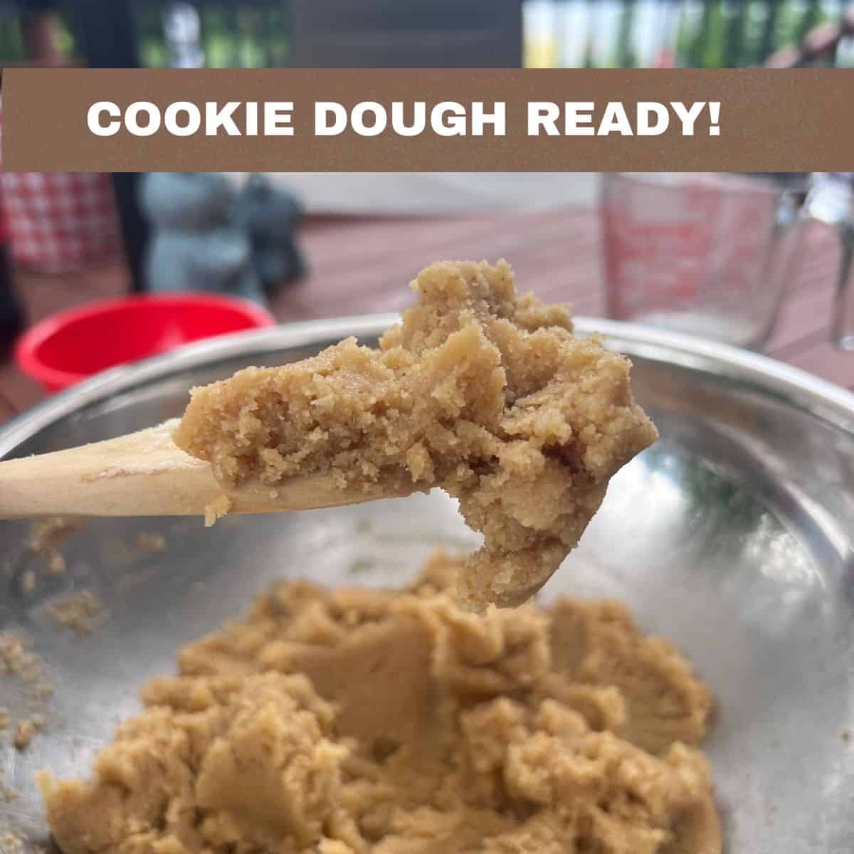 Soft almond flour cookie dough on a wooden spoon after mixing all the ingredients for Almond Flour Butter Cookies.
