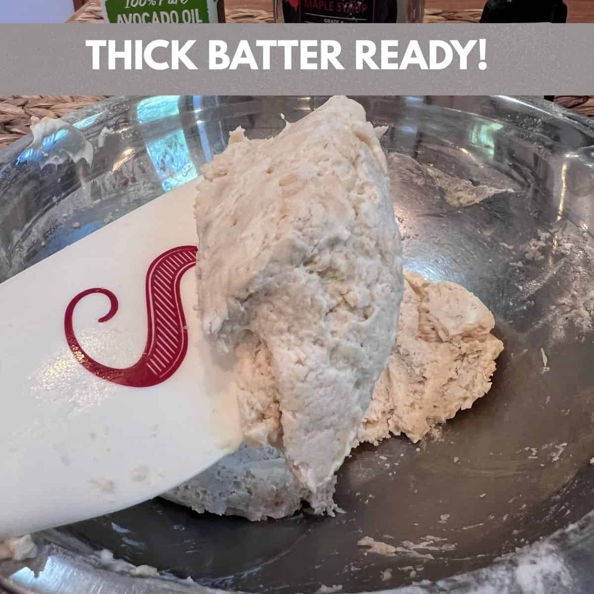 Thick cobbler batter on a spatula made with self-rising flour, Greek yogurt, almond milk, avocado oil, maple syrup, and vanilla for an Easy 5-Ingredient Shortcut Blueberry Cobbler.