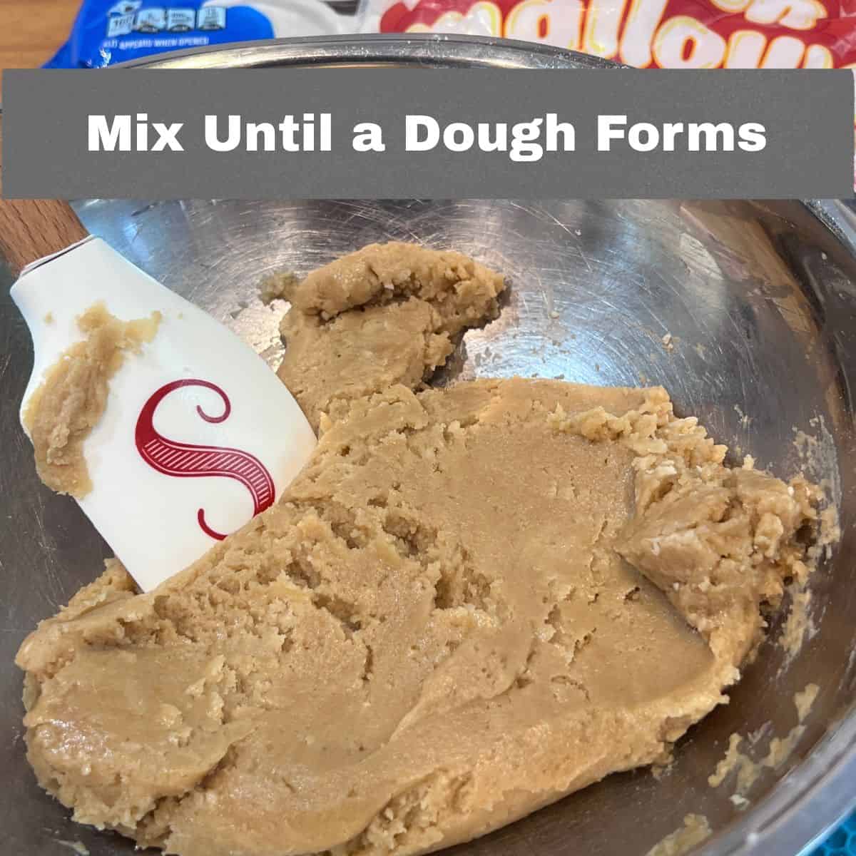 Oreo chocolate chip marshmallow cookie dough in a mixing bowl after adding the dry ingredients