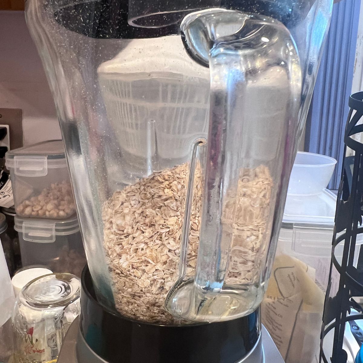 Rolled oats in a blender ready to make homemade oat flour