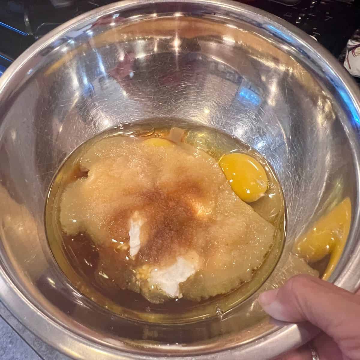 Wet ingredients mixed in a bowl for healthy apple fritter muffins